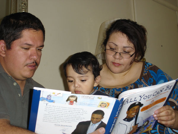 Parents reading book to son.