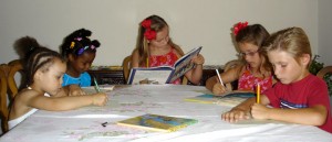 Five children reading and writing