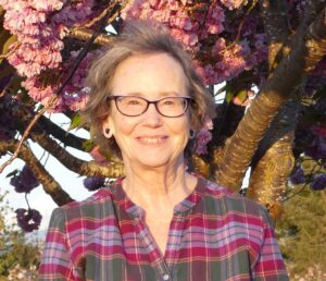 Carola Tossetti portrait with cherry blossoms at the community college.